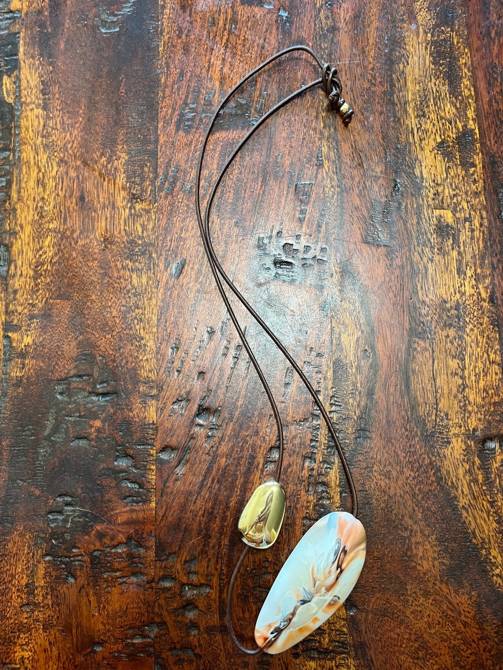 Dinosaur Designs horn and brass bead long and adjustable cord. 
Boho Statement